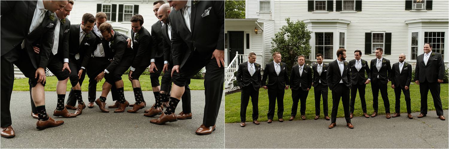 Groomsmen showing off socks and posing for group portrait
