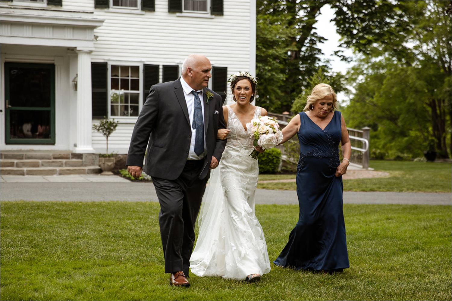Bride walking down aisle with mother and father