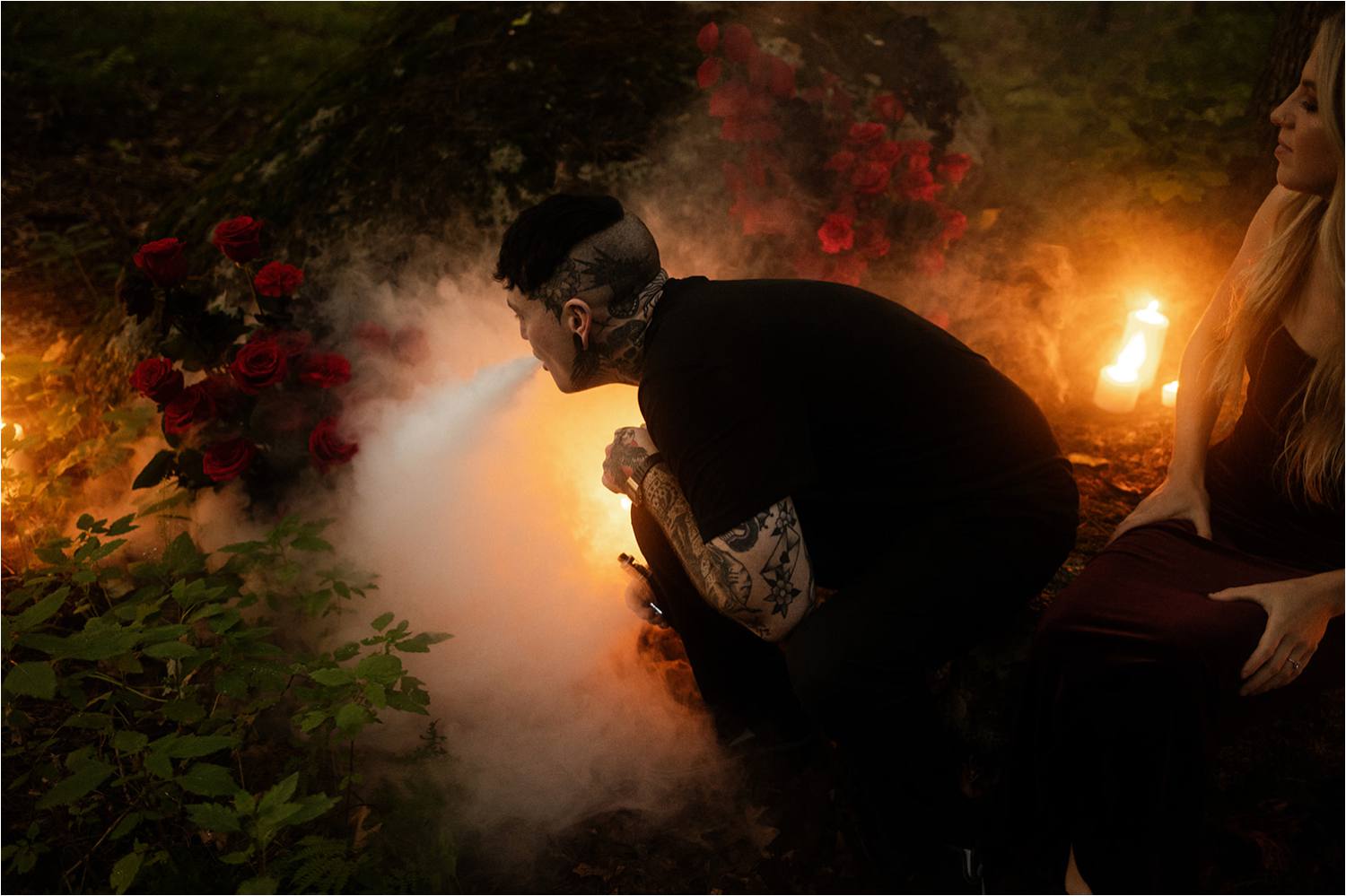 Tattooed man blowing vape for smoke effect during boston engagement session