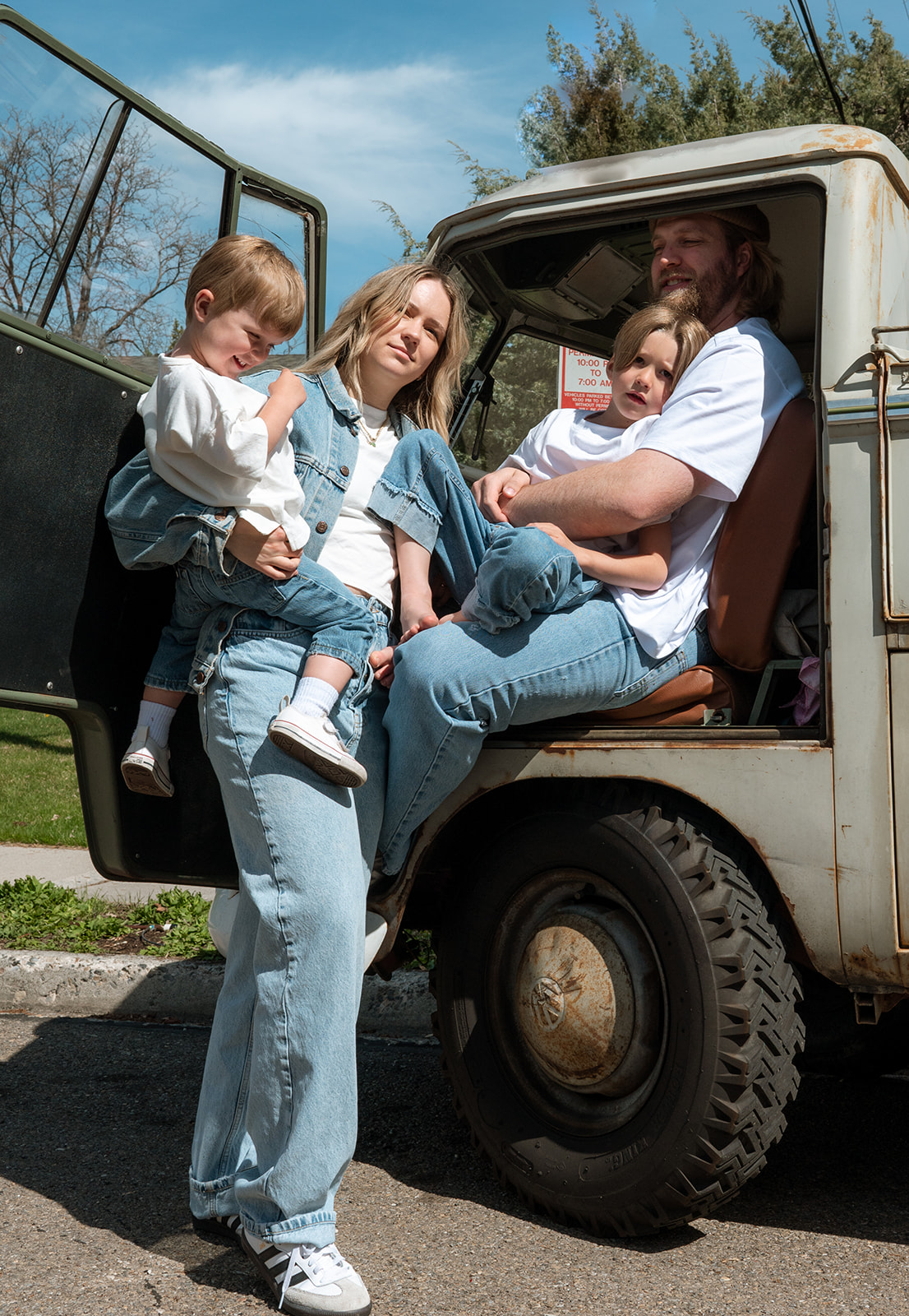 family of 4 sits together in VW truck in Provo Utah
